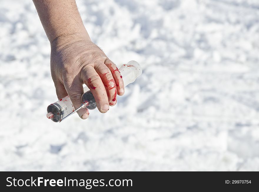 Bloody Hand Holding Syringe