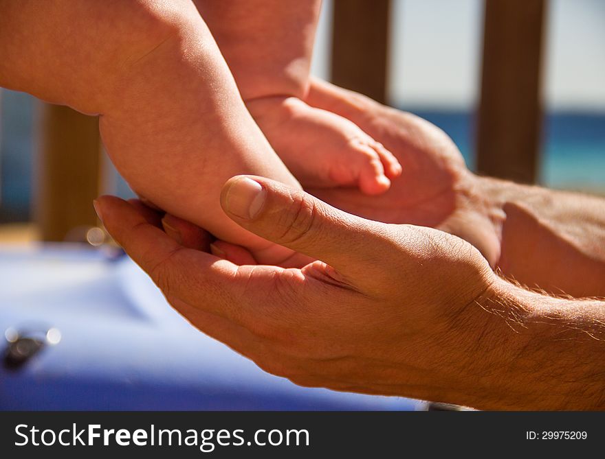 A father holding his baby s feet