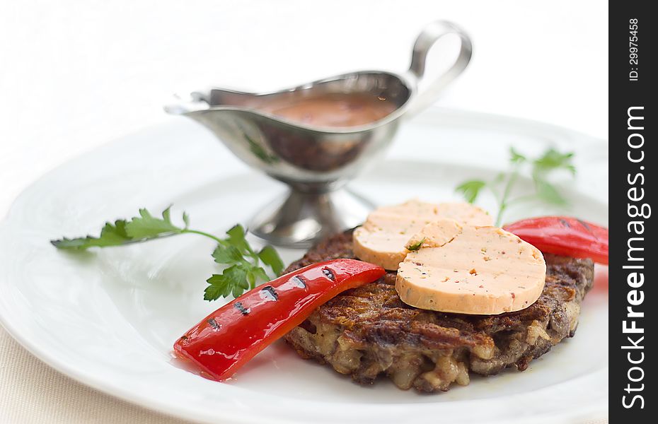 Meat with red pepper on a plate