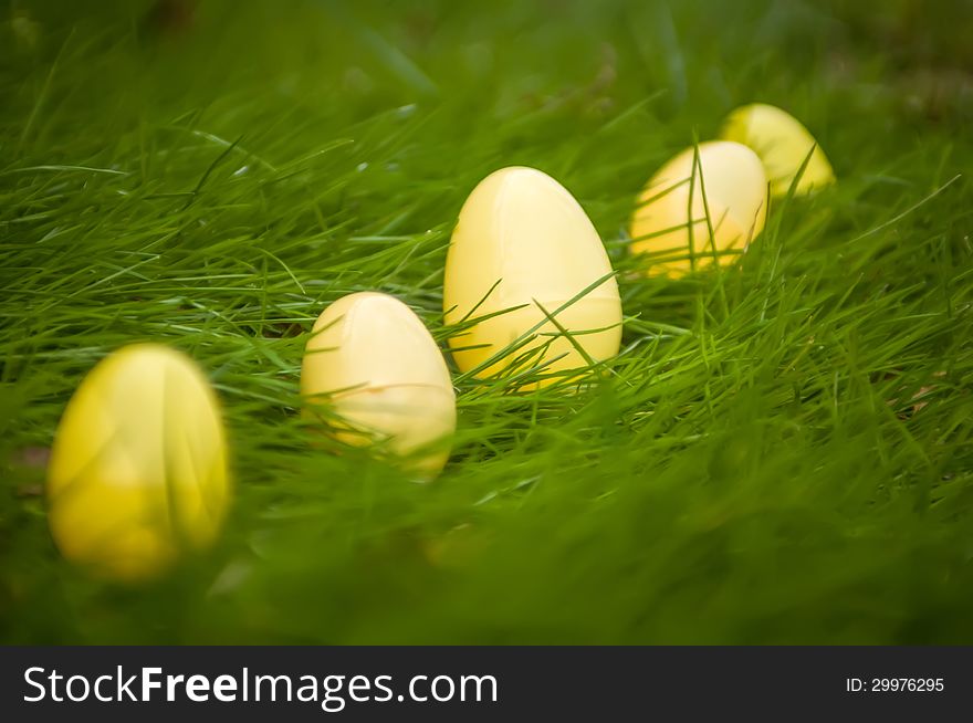 Easter eggs in grass background randomly scattered
