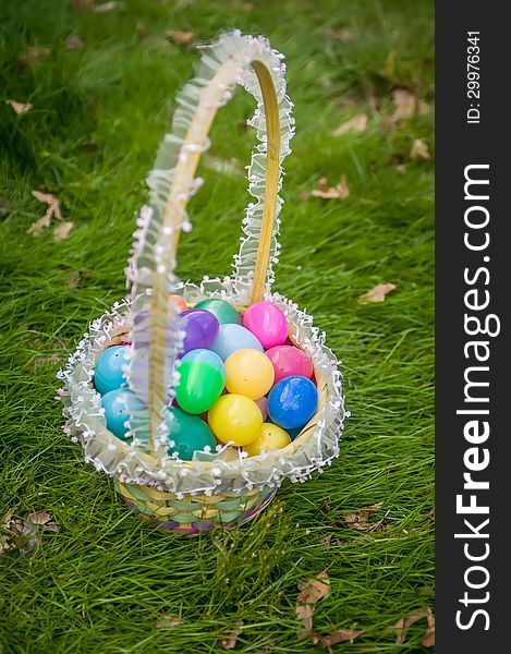 Easter eggs basket on grass background
