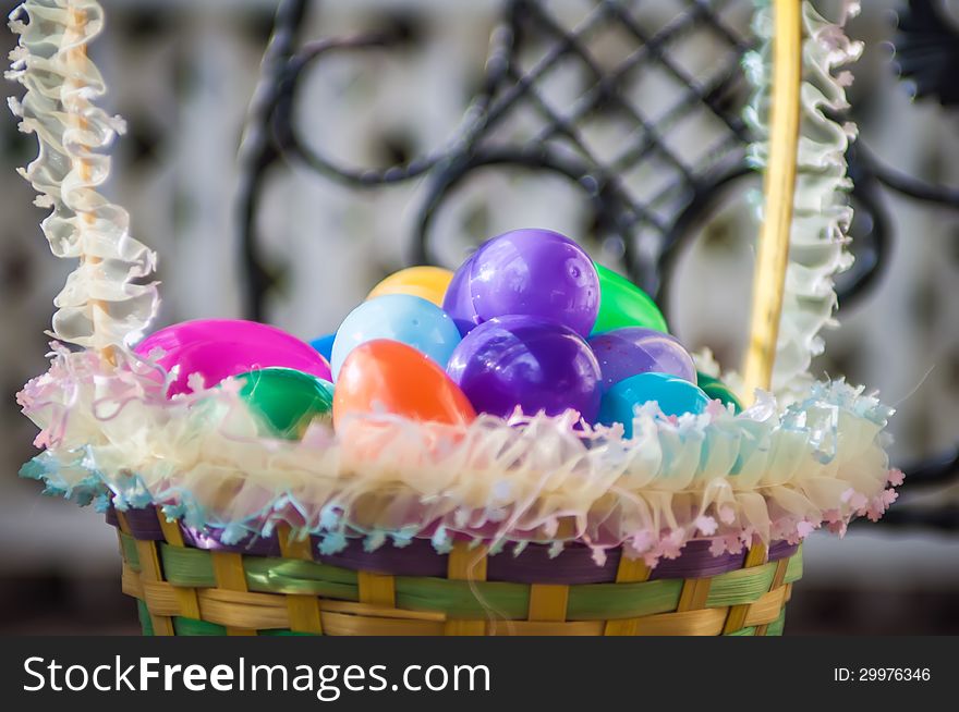 Easter eggs basket on chair with lattice background
