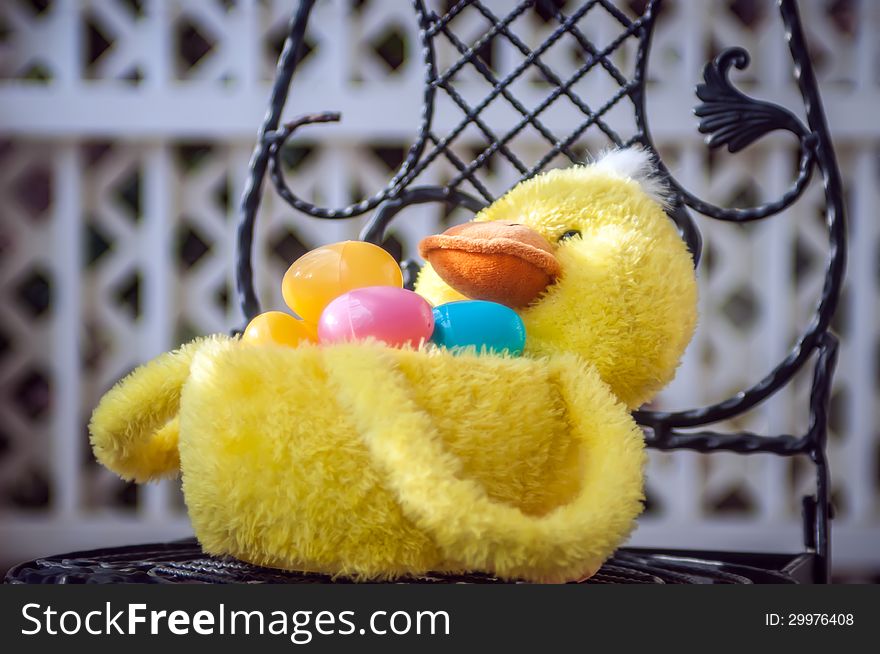 Easter duck basket with lattice background on a chair