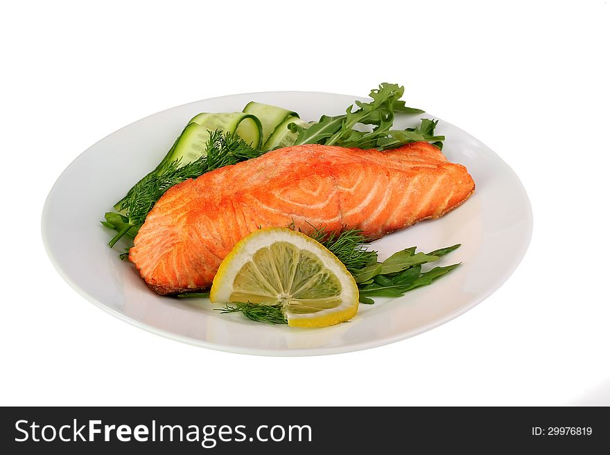 Grilled salmon with green, fresh lettuce.Isolated on white background.