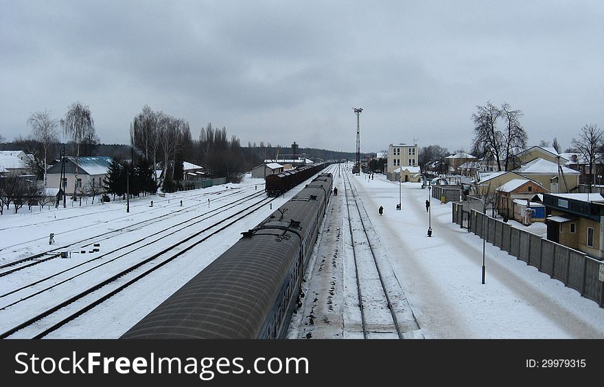 Panorama to railway station and rails in winter