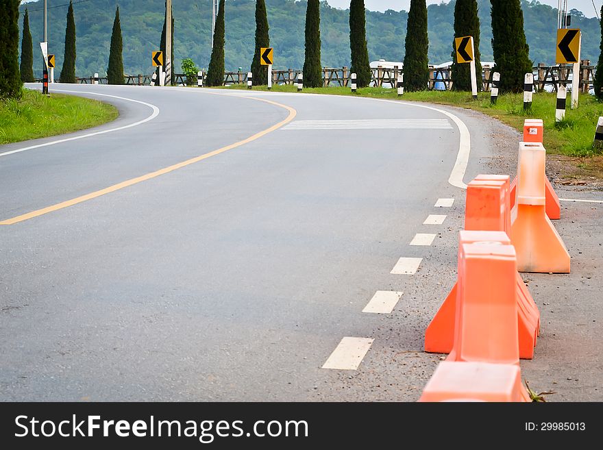 Uphill curve road with road sign