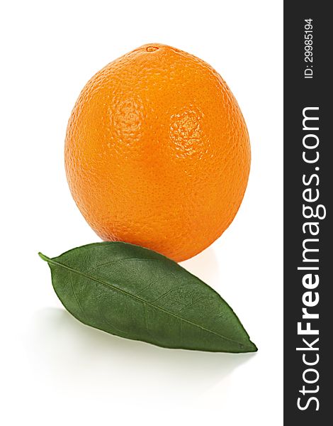 Ripe orange fruit with leaves on white background