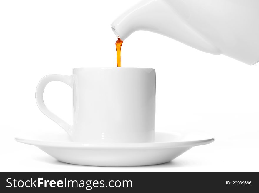 Pouring tea into a cup. Pouring tea into a cup