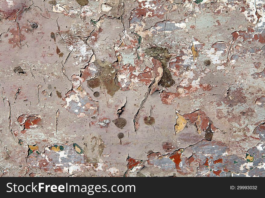 Old cracked paintwork from underneath a wooden boat