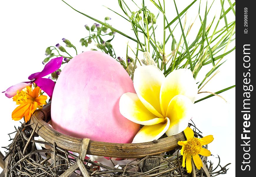 Easter egg in the basket with flowers