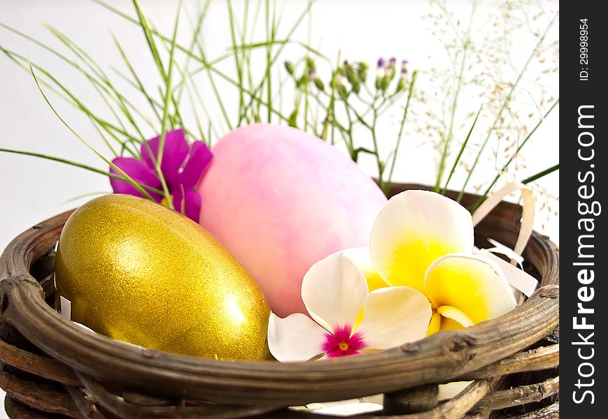 Easter egg in the basket with flowers