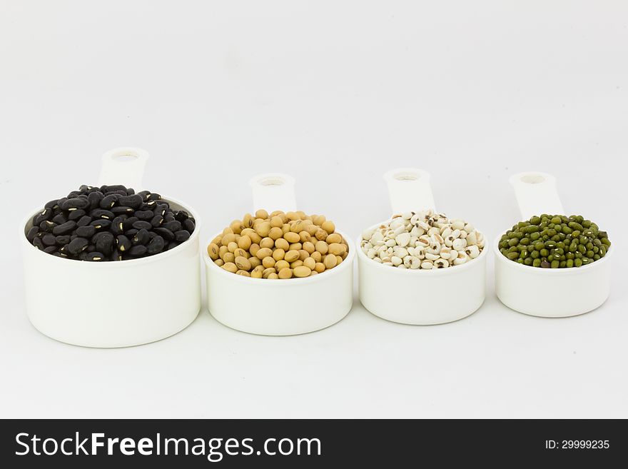 Soybean,black bean,mung bean,millet in measuring cup. Soybean,black bean,mung bean,millet in measuring cup