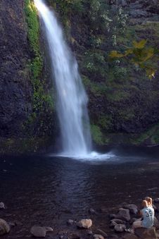 Couple Sitting In Front Of Waterfall. Stock Photos Couple Sitting In Front Of Waterfall. Stock Photos