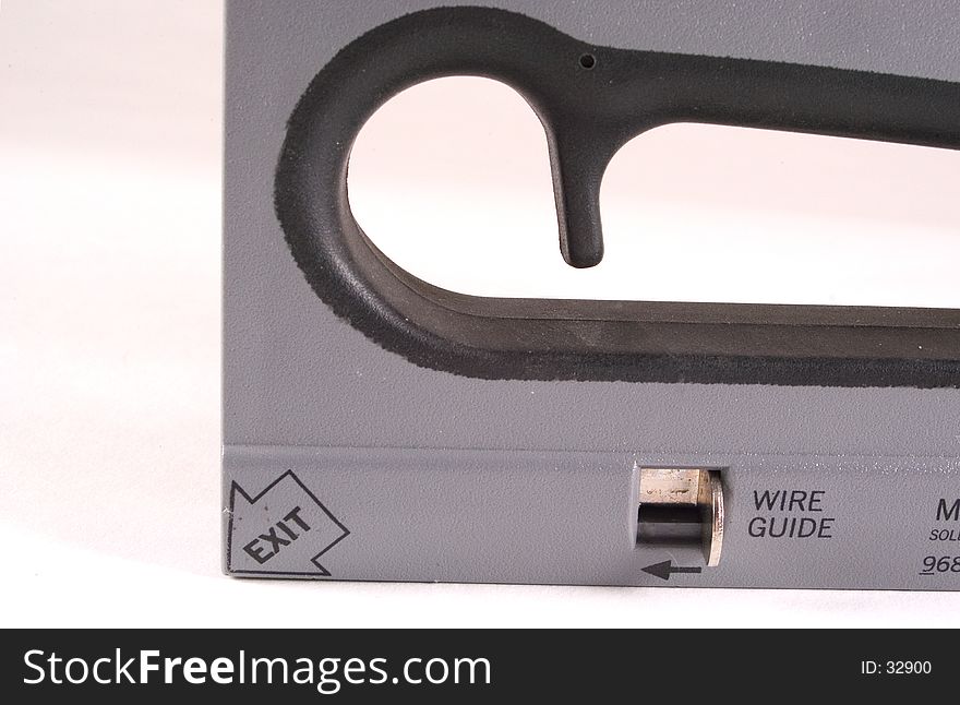 Detail of a power stapler showing the wire guide and part of the hand grip area. Detail of a power stapler showing the wire guide and part of the hand grip area.