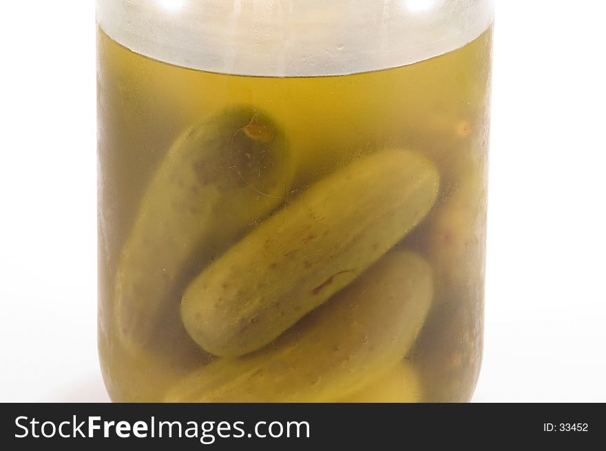 Large dill pickles floating in a jar covered with condensation. Focus is on jar front and condensation causing pickles to have a diffused look. Large dill pickles floating in a jar covered with condensation. Focus is on jar front and condensation causing pickles to have a diffused look