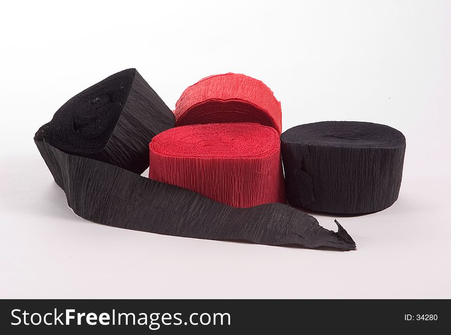 Black and red crepe paper in a roll used for party decorations.