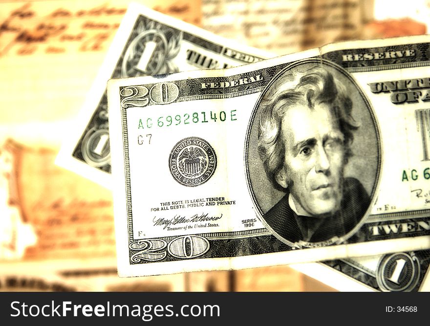 Photo of a Twenty and a Dollar With Old Docuemtns in Background. Blur and Color Effect. Photo of a Twenty and a Dollar With Old Docuemtns in Background. Blur and Color Effect.