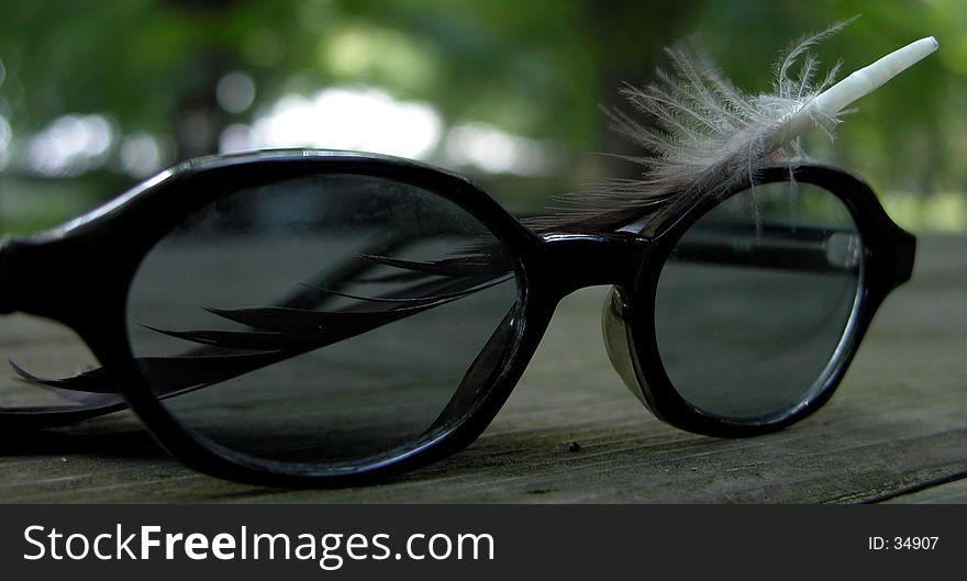 Eye glasses and feather. An image which can be on a cover page of a biographic novel...it's only an idea. Eye glasses and feather. An image which can be on a cover page of a biographic novel...it's only an idea...