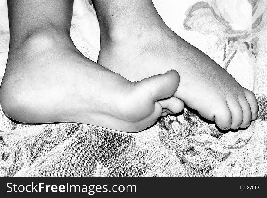 Black and white image of little childs feet. Black and white image of little childs feet.