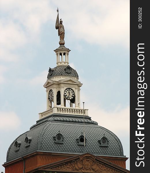 A Beautiful clock tower of a very old building. A Beautiful clock tower of a very old building