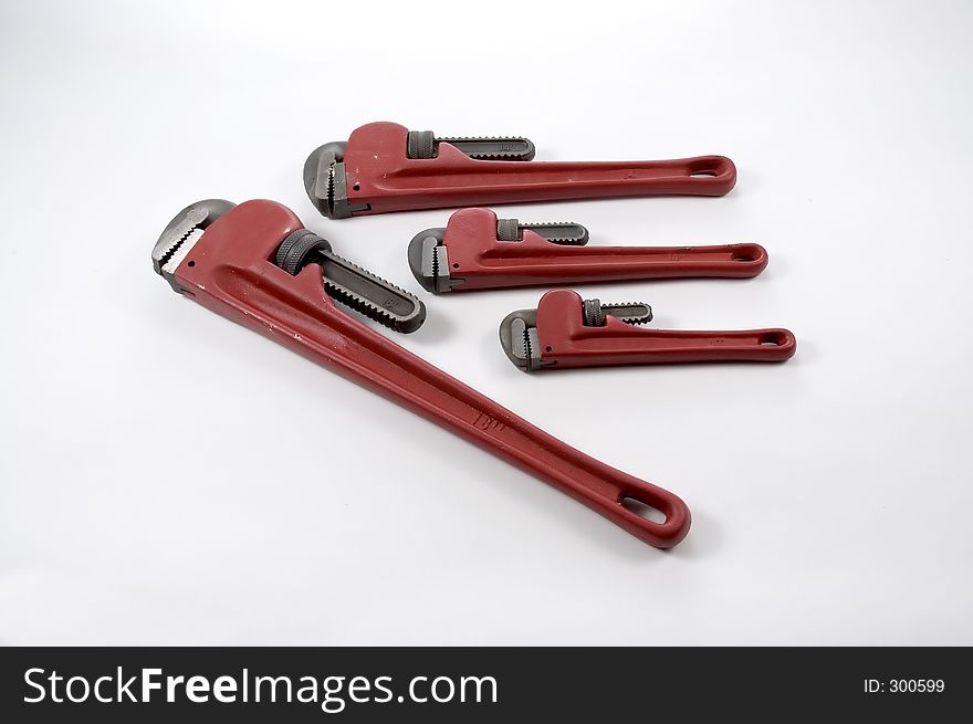 A set of monkey wrenches in various sizes photographed on a white background