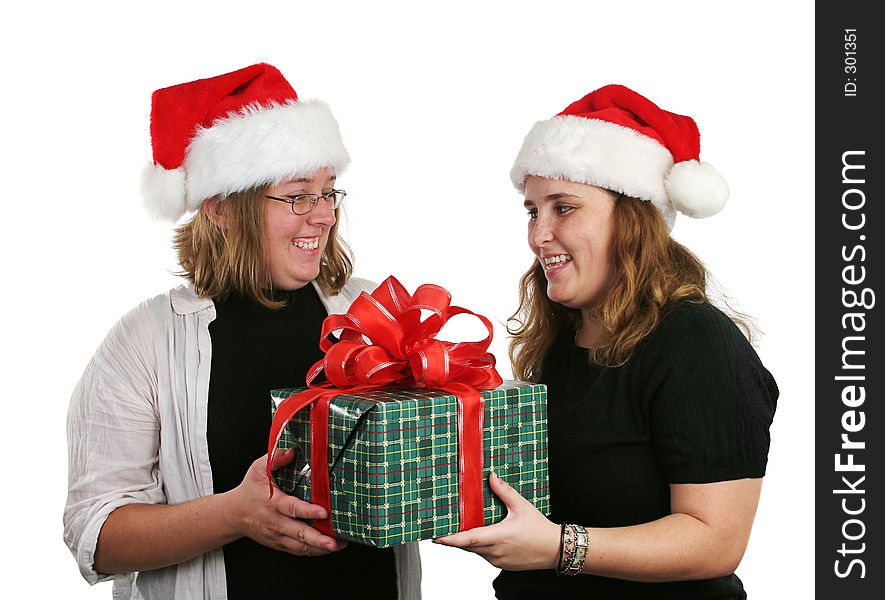 Two girls exchanging Christmas gifts. Two girls exchanging Christmas gifts.