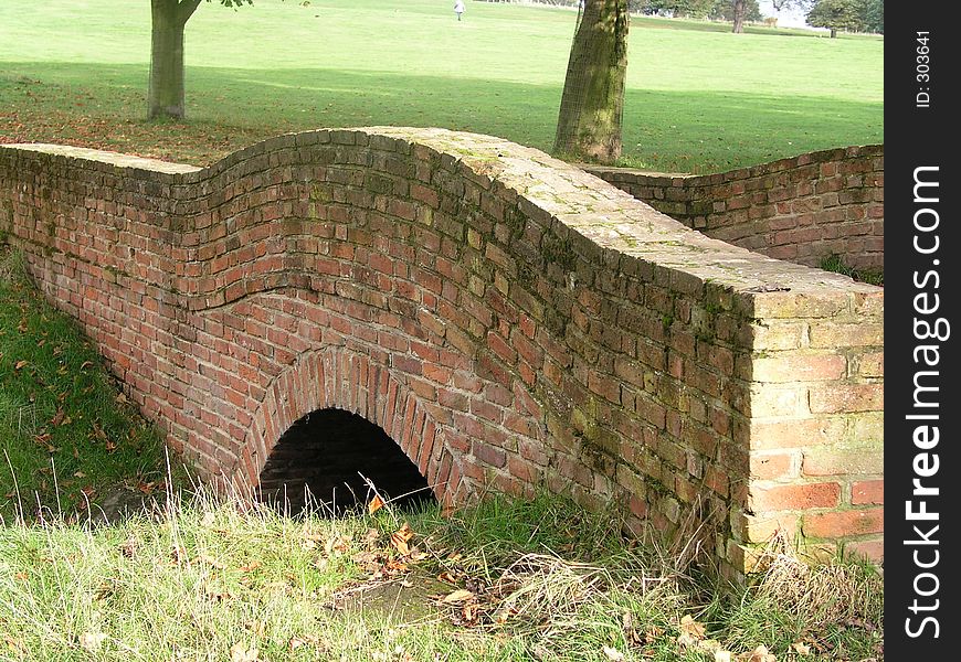 A red-brick bridge over a stream in the English countryside. A red-brick bridge over a stream in the English countryside.