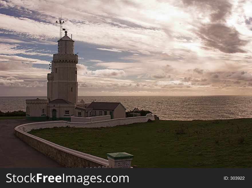 Lighthouse with sea and stormy sky in background. Lighthouse with sea and stormy sky in background
