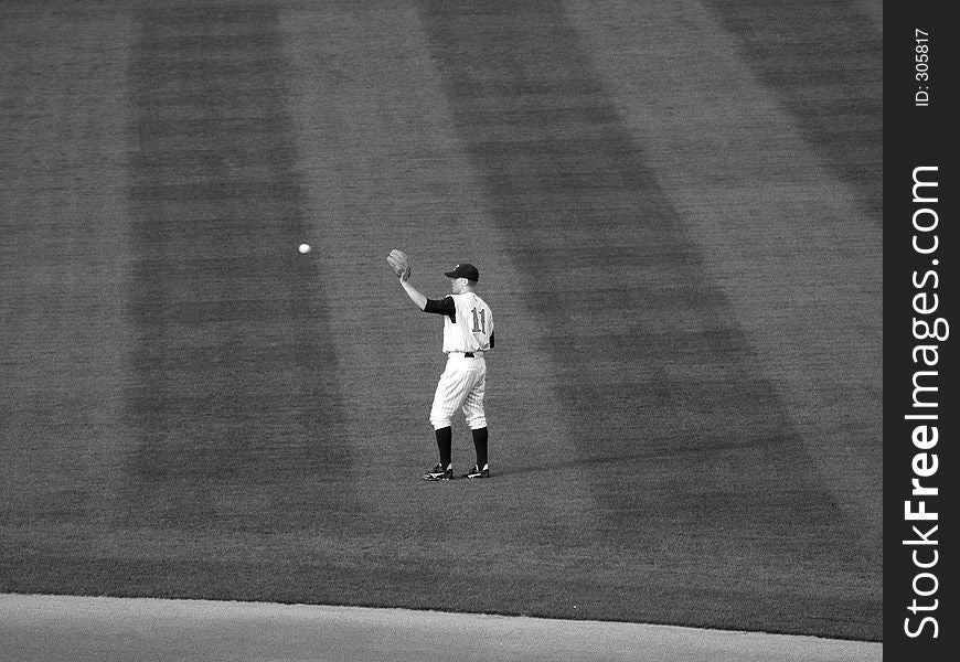 Local farm team Baseball player about to catch a baseball (B&W). Local farm team Baseball player about to catch a baseball (B&W)