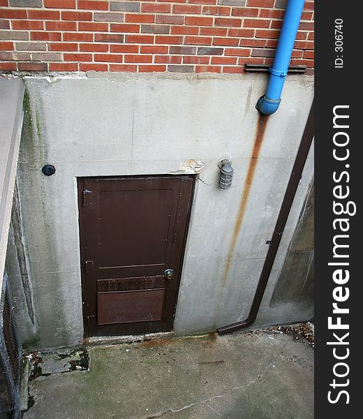 Little-used basement door of industrial building. Little-used basement door of industrial building