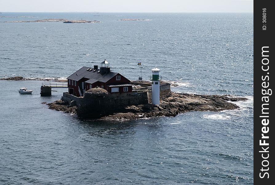 Small island with lighthouse near Swedish coast