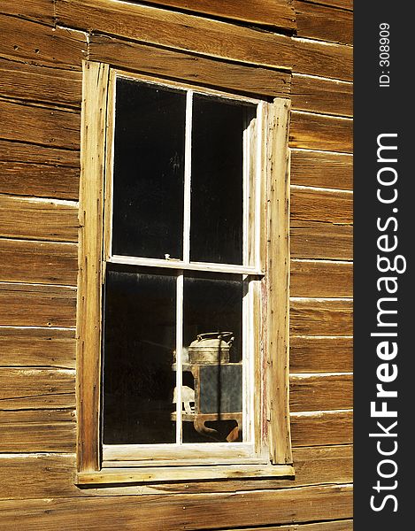 View of a kitchen through a ghost town window.