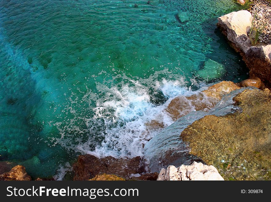 A lovely waterfall with blue colored water in this landscaping design. A lovely waterfall with blue colored water in this landscaping design