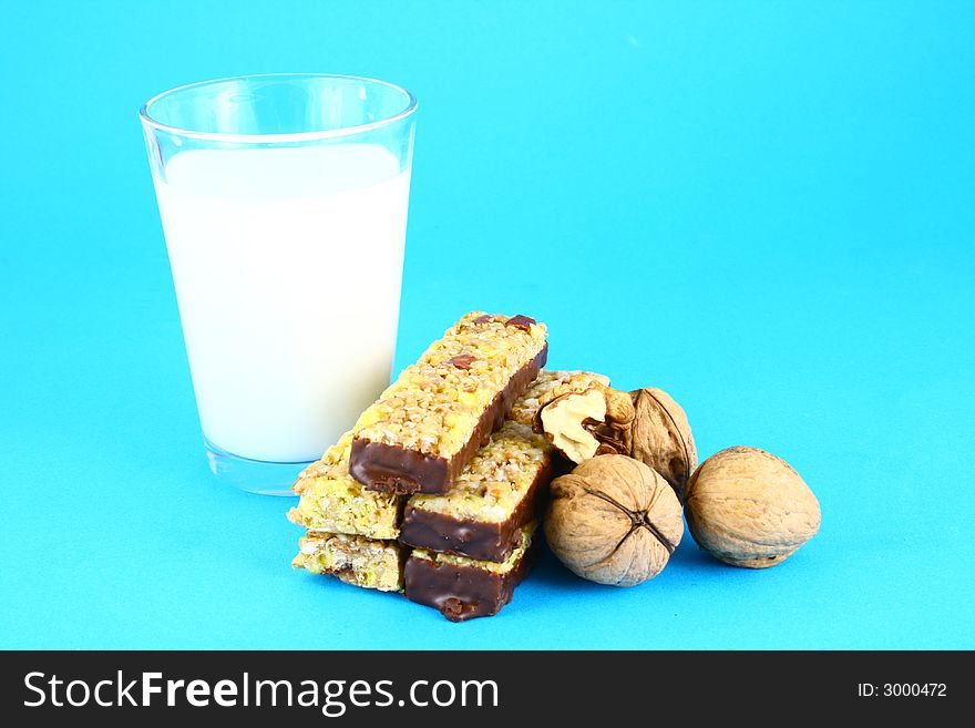 Pouring white milk against blue background and glass. Pouring white milk against blue background and glass