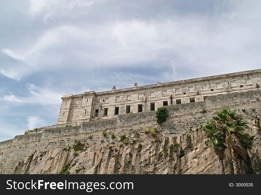 An old abandoned prison on a cliff against the sky. An old abandoned prison on a cliff against the sky