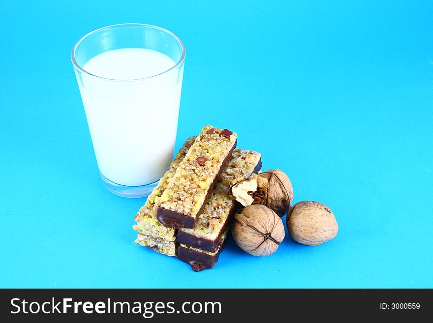 Pouring white milk against blue background and glass. Pouring white milk against blue background and glass