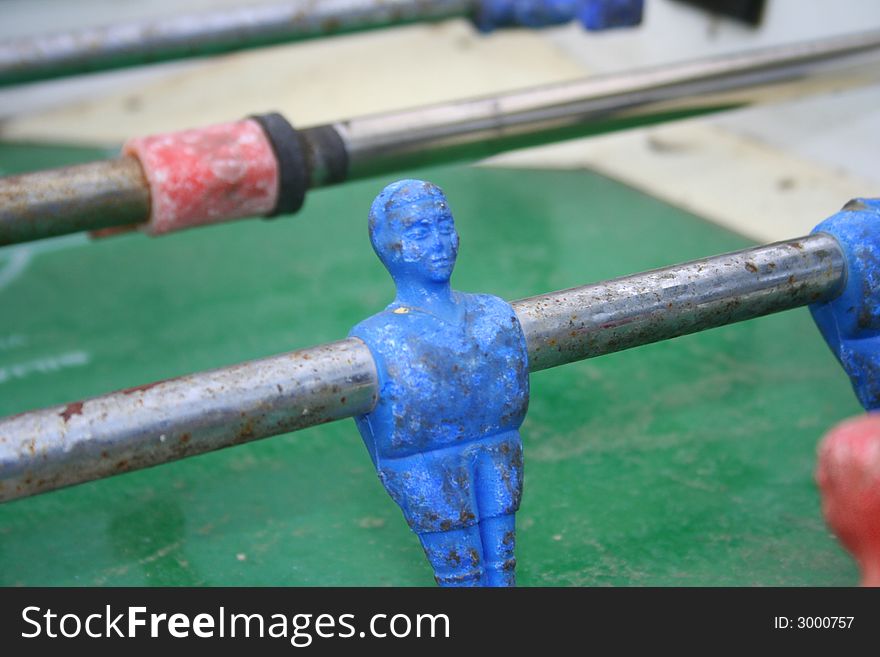 Closeup of a blue player in an old table football. Closeup of a blue player in an old table football