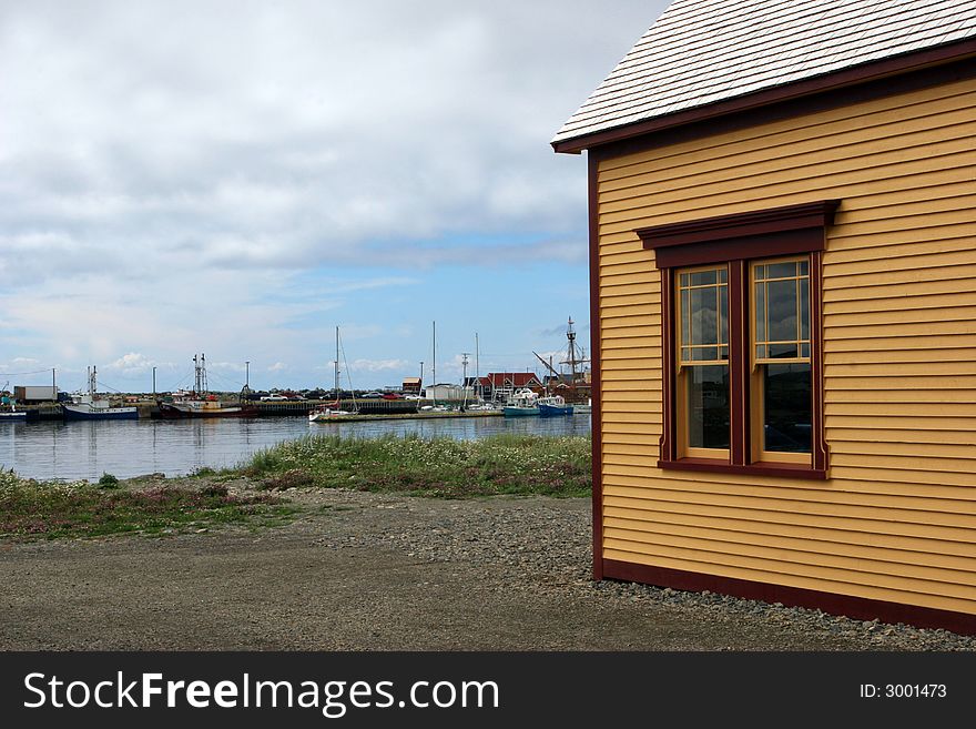 Historical building overlooking docked boats in Newfoundland, Canada. Historical building overlooking docked boats in Newfoundland, Canada.