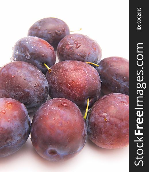 Fresh plums isolated over white background