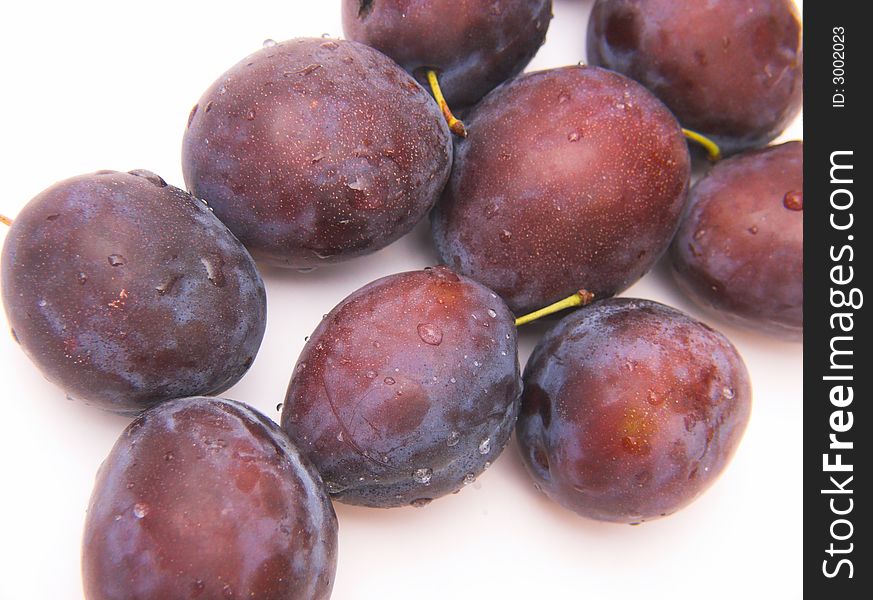 Fresh plums isolated over white background