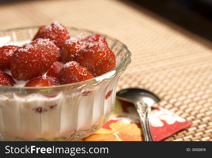 Juicy strawberries with cream, cup, teaspoon, napkin