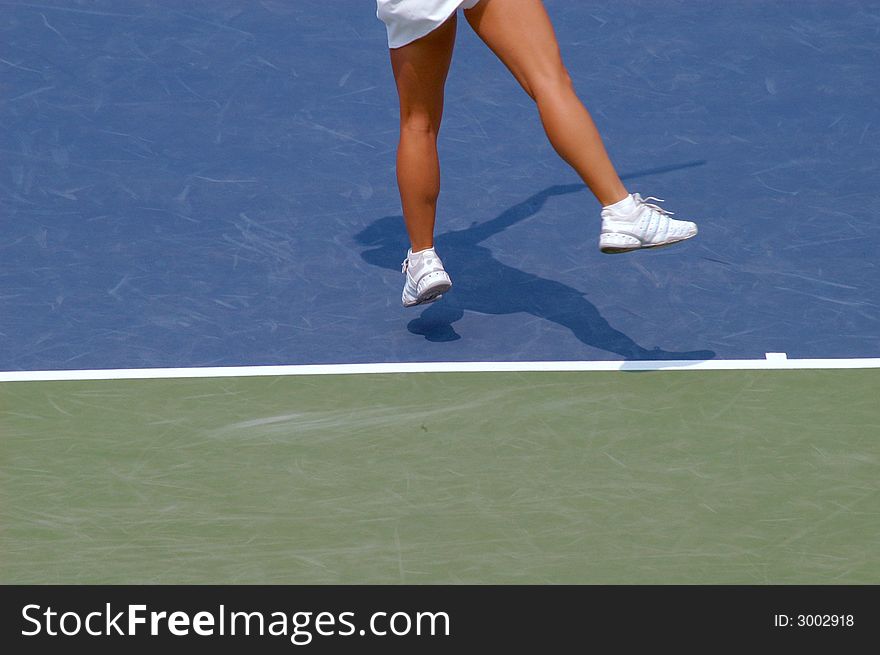 the shadow of a women playing tennis . the shadow of a women playing tennis