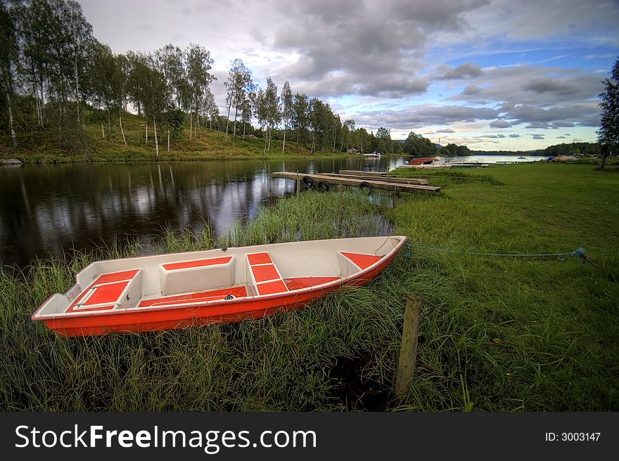 Norwegian river scenic, evening colours, red boat in the foreground.

<a href='http://www.dreamstime.com/beauty-of-norway-rcollection5045-resi208938' STYLE='font-size:13px; text-decoration: blink; color:#FF0000'><b>BEAUTY OF NORWAY COLLECTION Â»</b></a>. Norwegian river scenic, evening colours, red boat in the foreground.

<a href='http://www.dreamstime.com/beauty-of-norway-rcollection5045-resi208938' STYLE='font-size:13px; text-decoration: blink; color:#FF0000'><b>BEAUTY OF NORWAY COLLECTION Â»</b></a>