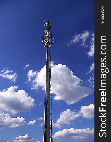 Cell phone antenna pillar in sunny day with white clouds. Cell phone antenna pillar in sunny day with white clouds