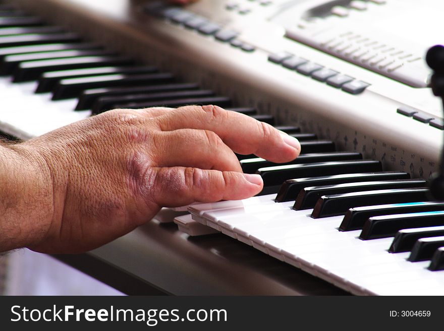 A hand playing the piano