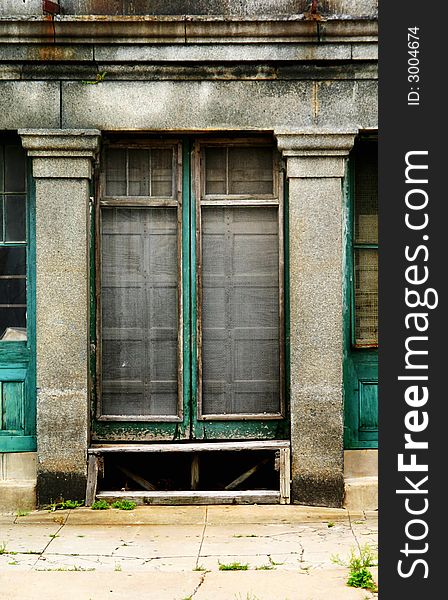 Decrepit abandoned urban doorway with moldy concrete and peeling paint. Decrepit abandoned urban doorway with moldy concrete and peeling paint.