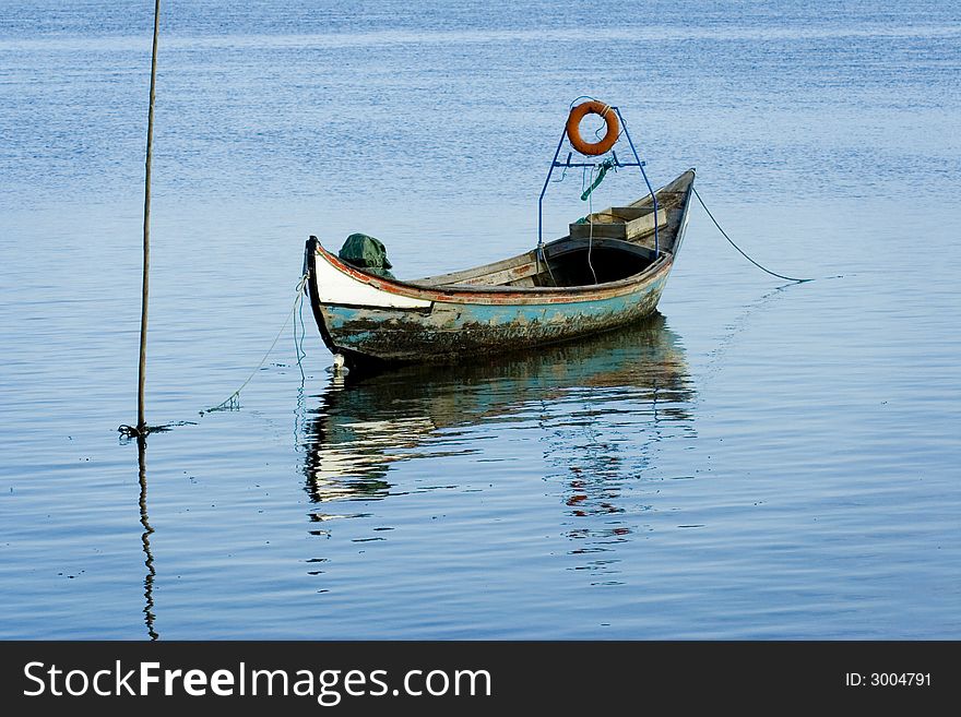 Old fishing boat with reflexion in water