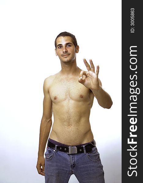 Young shirtless male portrait doing OK sign with a hand - isolated over white. Young shirtless male portrait doing OK sign with a hand - isolated over white