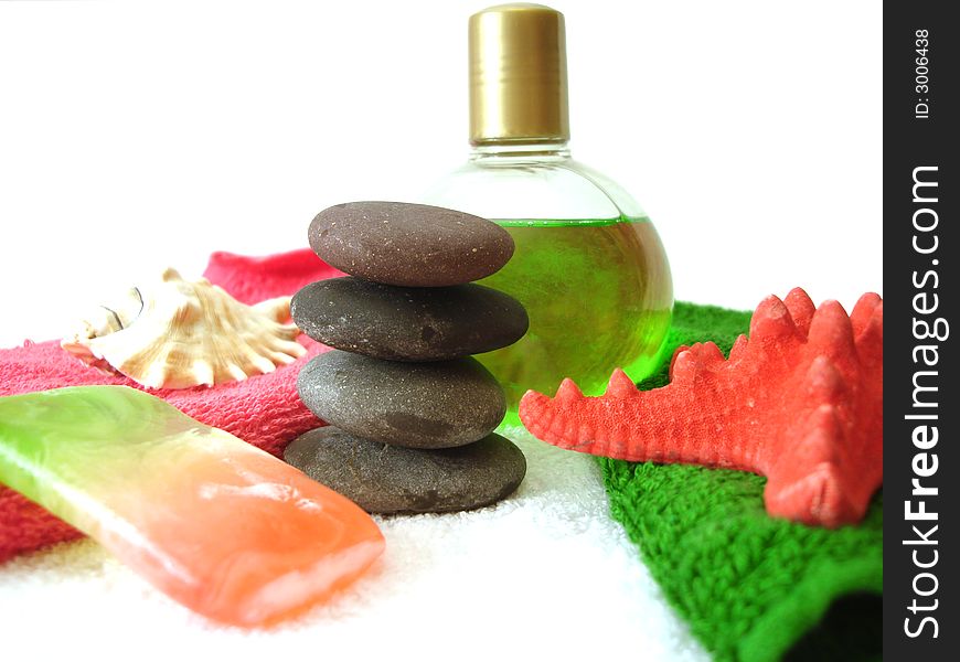 Spa essentials (pyramid of stones with towels, soap, seashell and shampoo)