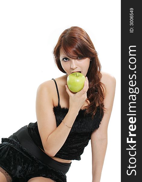 The beautiful girl eats a green apple. The beautiful girl eats a green apple